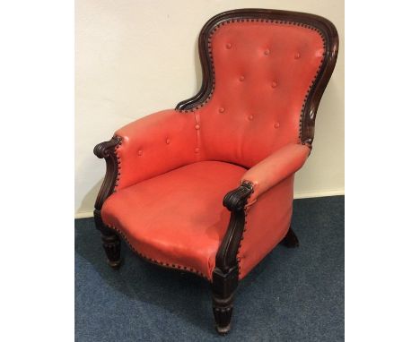 A good leather and mahogany button back chair with wavy edge and reeded feet. Est. £100 - £150.
