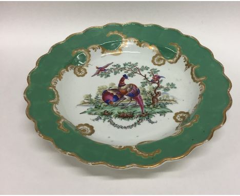 An early Worcester dessert plate decorated with peacocks. Approx. 21 cms in diameter. Est. £40 - £60.