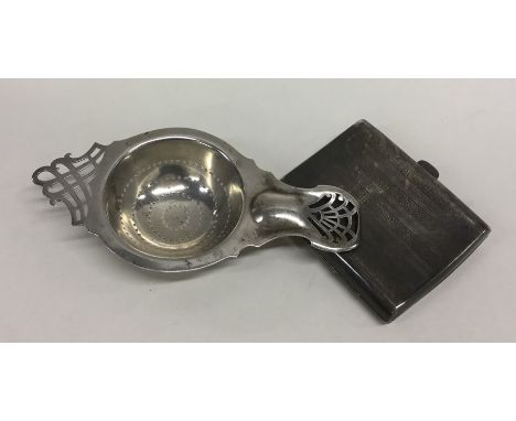 A stylish silver tea strainer together with an engine turned cigarette case. Approx. 157 grams. Est. £20 - £30.