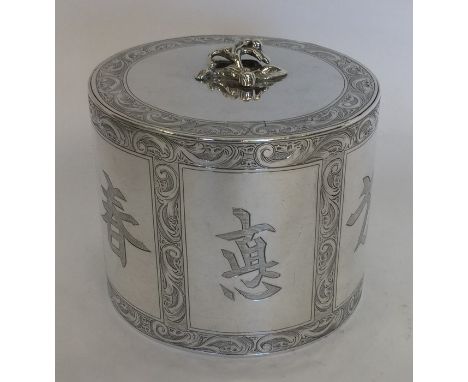 An unusual Georgian silver cylindrical tea caddy attractively decorated with flowers and scrolls to flush hinged lid, and Chi