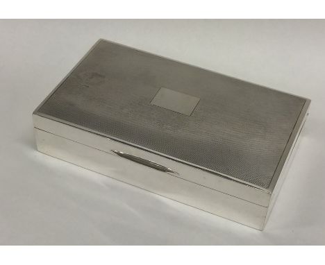 A good quality silver engine turned cigarette box with hinged top. Birmingham. Approx. 332 grams. Est. £50 - £80.