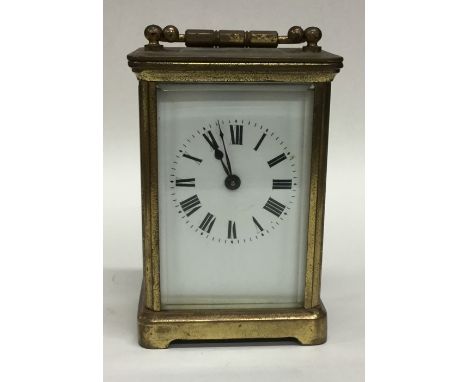 A small brass cased carriage clock with white enamelled dial. Est. £20 - £30.