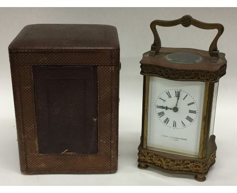 A brass carriage clock with white enamelled dial in fitted travelling case. Est. £40 - £60.