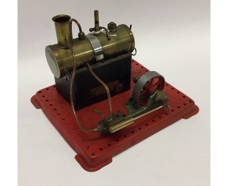 A Mamod steam engine on red base with burner. Est. £40 - £50.