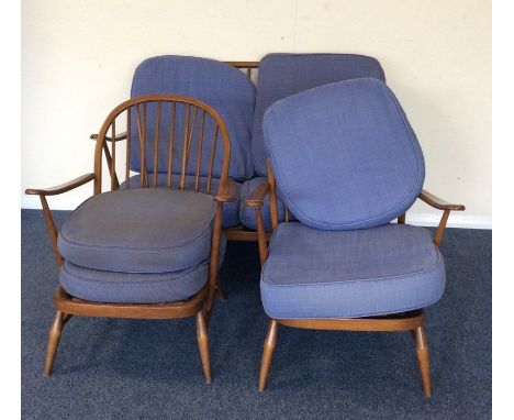An Ercol three piece settee suite. Est. £60 - £80.