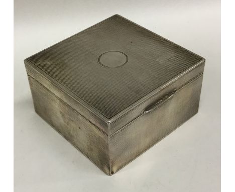 A silver engine turned cigarette box with hinged top. Approx. 301 grams. Est. £30 - £50.