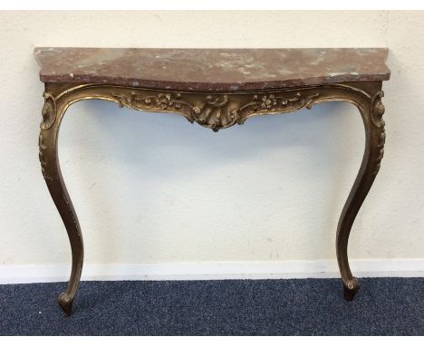 A gilt marble top console table decorated with scrolls. Est. £50 - £80.