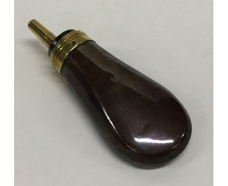 An unusual small brass and copper shot flask with spring mechanism. Est. £40 - £60.
