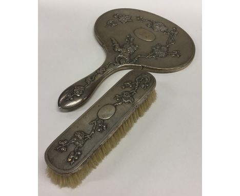 A heavy Chinese silver dressing table mirror together with matching brush of typical design. Punched to rim. Approx. 800 gram