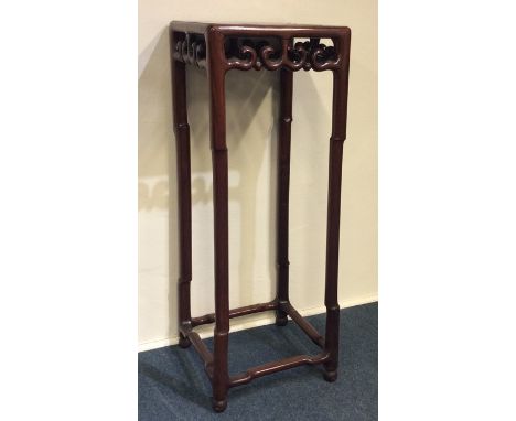 A good quality hardwood tall planter carved with scrolls. Est. £300 - £400.