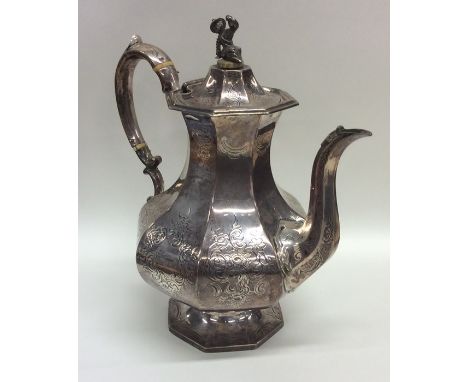 A heavy Victorian silver coffee pot decorated with engraving. Approx. 896 grams. Est. £300 - £400.