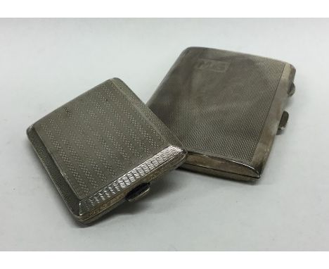 Two silver engine turned cigarette cases. Approx. 106 grams. Est. £25 - £35.