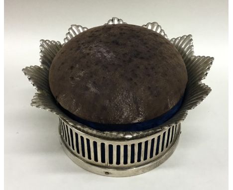 A large Continental silver pin cushion with flowering sides. Approx. 320 grams. Est. £60 - £80.