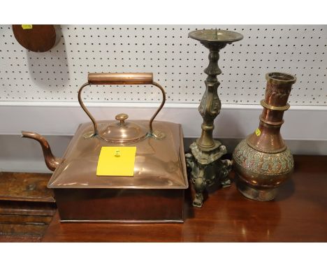 A pricket candlestick of 17th century design, 15" high, an embossed copper vase, 12" high, and a copper kettle, 11 1/2" squar