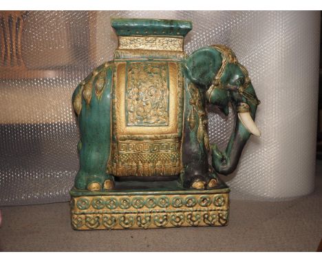 A green glazed ceramic elephant stool, 21 1/2" high 