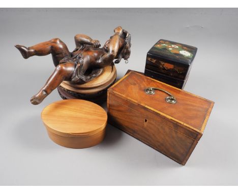 Two hardwood vase stands with pierced decoration, a carved hardwood figure of cherub, 13" high, a mahogany tea caddy, convert