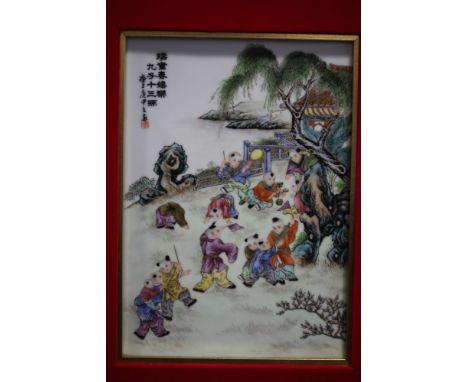 A pair of Chinese porcelain panels, decorated figures playing in a garden and verse, 10" x 7", in mount and gilt frames 