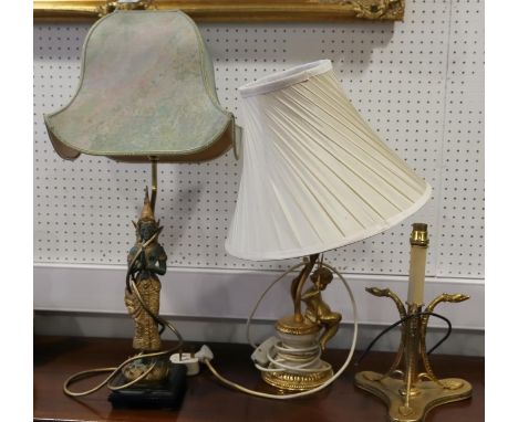 A gilt cherub table lamp and shade, 21" high, a tripod table lamp, 12" high, and a Thai style table lamp 