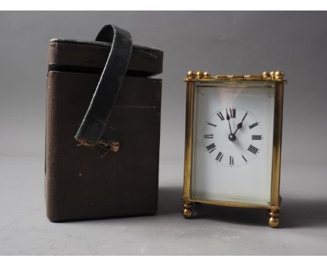A brass cased carriage clock with travelling case, clock 4 1/2" high 