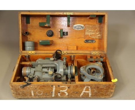 A vintage theodolite, by Cooke, Troughton &amp; Simms, in wooden travel case, and&nbsp;a surveyor's level and target, in trav