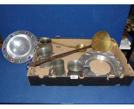 A brass skimmer and ladle and four pewter tankards.