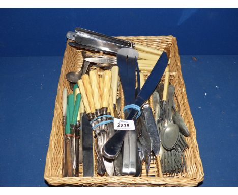 A quantity of cutlery to include: butter knives, dinner knives, salad servers, carving knife and fork, etc.