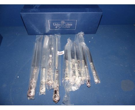 A quantity of Sheffield silver handled Knives to include: a carving knife set, a sharpening  stone and steak knives by United
