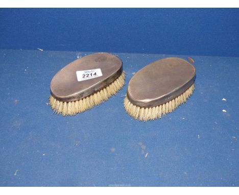 A pair of silver backed clothes Brushes with engine turned detail, hallmark for Birmingham.