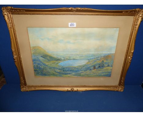 An ornate framed and mounted Watercolour depicting a country landscape with reservoir and hills in the distance, signed lower