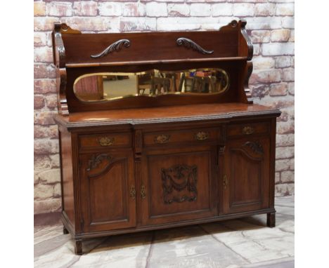 LATE VICTORIAN WALNUT MIRROR-BACK SIDEBOARD of breakfront outline, three frieze drawers above three cupboards on raised feet,