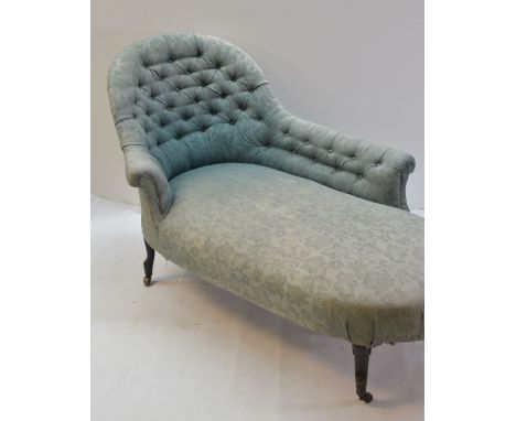 EDWARDIAN CHAISE LONGUE, spoon back and button upholstered in green damask material, on ebonised feet with casters, 166cms lo