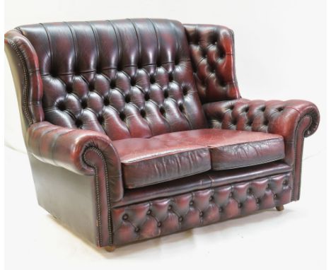 MAROON LEATHER BUTTON-BACK UPHOLSTERED WING-BACK SETTEE, with two loose cushions, 91h x 140w x 87cms