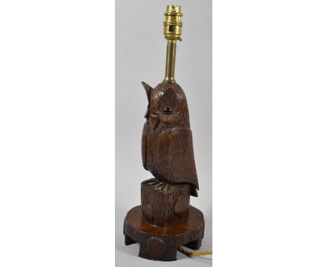 A Black Forest Carved Wooden Table Lamp in the Form of an Owl with Glass Eyes, 43cm high 