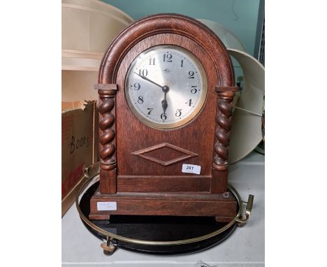 1950's oak-cased mantel clock with barley twist columns and Arabic numerals and a black and brass circular drinks tray (2) 