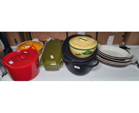 Various Le Creuset and other cast iron casseroles in orange, red, green and black, five graduated ear dishes and a ceramic ca
