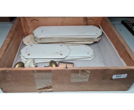 Vintage box containing white ceramic door plates, brass door handles, etc