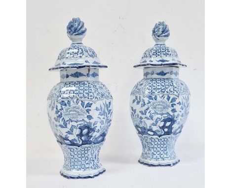 Pair of 18th century Dutch Delft vases with covers of hexagonal baluster form, the domed covers with flamed torch finials abo