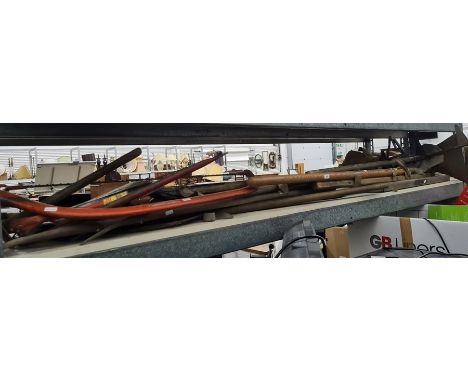 Large collection of vintage gardening and agricultural implements including hand plough, bamboo drain rods, two-handled saw a