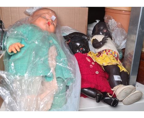 Vintage African black baby doll, another and two celluloid large baby dolls (4) 