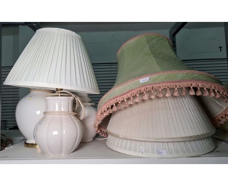 Three cream ceramic table lamps, not matching and four pleated shades of various sizes (7) 