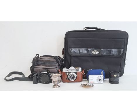 Paxette Reflex camera, a Minolta camera and lens in carry case, a Vivitar digital camera in blue case, a Minolta zoom lens, a