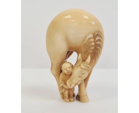 Japanese carved ivory netsuke, early Edo period, in the form of a horse bending down towards child, signed Tomotsugu, 6cm hig