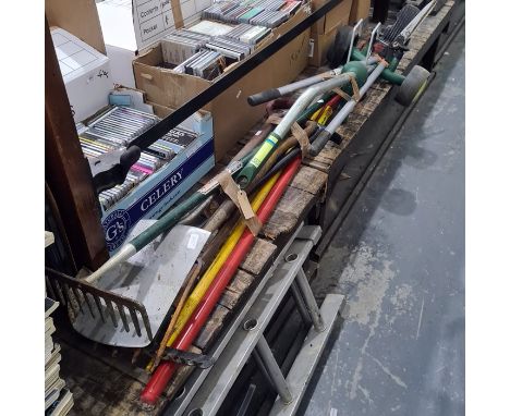 Collection of vintage and modern gardening tools including long reach loppers, spades, forks, rakes, etc 