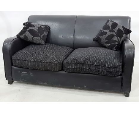 Modern black leather two-seater sofa bed with two scatter cushions 