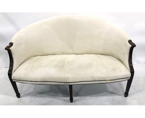 Early 20th century two-seat sofa in cream ground upholstery, reeded arm rests, on square section tapering supports to spade f