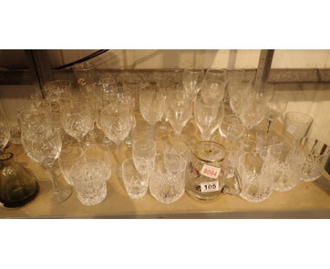 Shelf of assorted drinking glasses including crystal