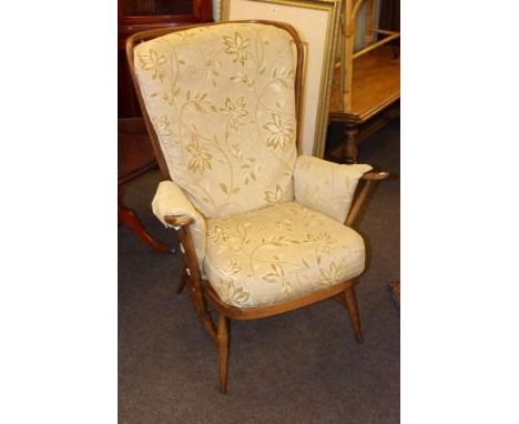 Ercol wood framed armchair in floral design fabric