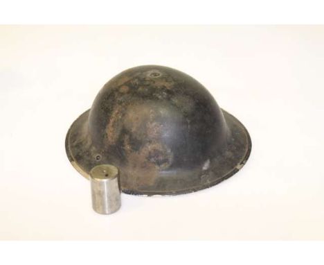 Helmet, stamped 1939; and a gauge