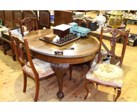 Oval Chippendale style dining table and leaf and four walnut Edwardian dining chairs