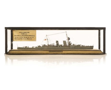 A RARE 1IN:32FT SCALE WATERLINE MODEL OF H.M.S. HAWKINS MODELLED BY NORMAN OUGH, 1926, the hull carved from the solid with pa